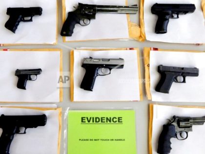 FILE-In this July 7, 2014 file photo, Chicago police display some of the thousands of illegal firearms they confiscated during the year in their battle against gun violence in Chicago. Hoping to stem the flow of illegal guns into Illinois, lawmakers have sent Republican Gov. Bruce Rauner legislation that would …