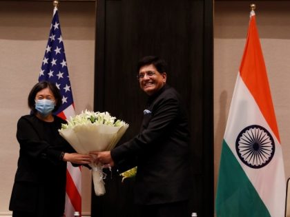 India's Minister of Commerce and Industry, Piyush Goyal, presents a bouquet to U.S. Trade Representative Katherine Tai before the start of their meeting in New Delhi, India, November 22, 2021. (Adnan Abidi/Pool Photo via AP)