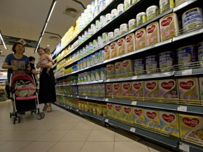 China New Zealand Botulism A woman carries a child past powdered milk products including cans of Dumex infant formula already inspected and deemed to be from a safe batch at a supermarket in Beijing, China, Monday, Aug. 5, 2013. The official Xinhua News Agency said Hangzhou Wahaha Health Food Co. …