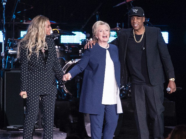 Jay Z, right, and Beyonce, left, stand with Democratic presidential candidate Hillary Clinton during a campaign rally in Cleveland, Friday, Nov. 4, 2016. (AP Photo/Matt Rourke)