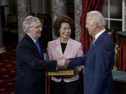 Elaine Chao (C) watches as her husband Senate Majority Leader Senator Mitch McConnell (R-KY) and US Vice President Joseph R. Biden(R) participate in a mock swearing-in in the Old Senate Chamber on Capitol Hill January 6, 2015 in Washington, DC. The 114th Congress convened today with Republicans taking majority control …
