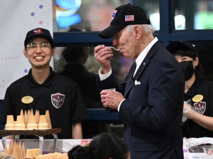 US President Joe Biden eats ice cream as he meets with members of the US military and their families at the bowling alley at Osan Air Base in Pyeongtaek on May 22, 2022. (Photo by SAUL LOEB / AFP) (Photo by SAUL LOEB/AFP via Getty Images)