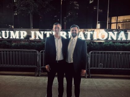 A picture of Senate candidates Blake Masters and J.D. outside the Trump international hotel.