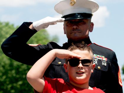 TOPSHOT - Jackson Leonard, age 8, the son of a US Marine, salutes with US Marine Corps Staff Sergeant Tim Chambers (Ret.) as motorcyclists participate in the Rolling to Remember ride near the Lincoln Memorial in Washington, DC, on May 29, 2022. (Photo by Stefani Reynolds / AFP) (Photo by …