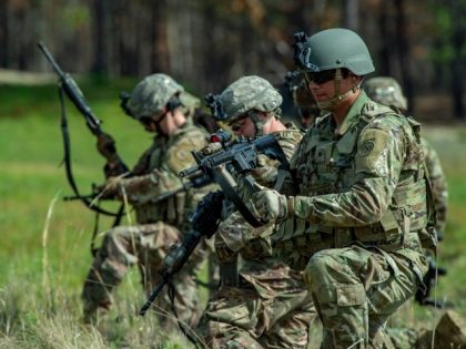 Members of the 182d Infantry Regiment load their weapons with live ammunition before heading into the field to train, firing on targets out in the field and working in concert with other squads, for deployment to the Middle East during live fire weapons training at US Fort Dix in New …