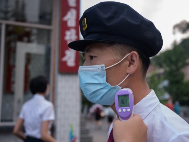 Students of the Pyongyang Jang Chol Gu University of Commerce undergo temperature checks before entering the campus, as part of preventative measures against Covid-19, in Pyongyang on August 11, 2021. (Photo by KIM Won Jin / AFP) (Photo by KIM WON JIN/AFP via Getty Images)