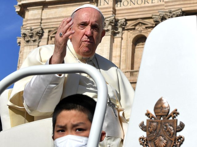 Pope Francis waves to worshippers upon his arrival for his weekly general audience in St.