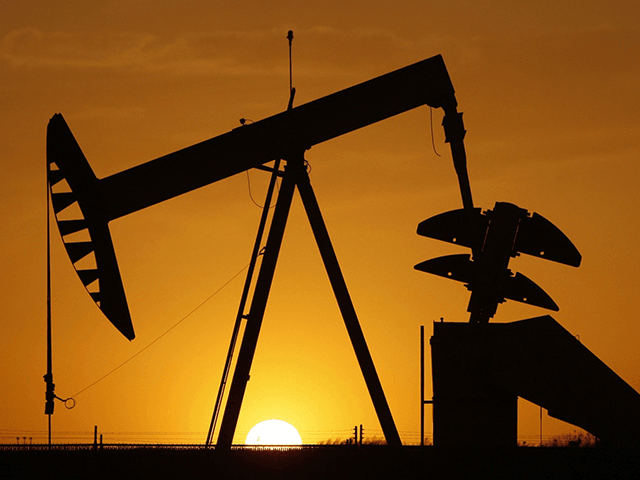 A pump jack is silhouetted against the setting sun in Oklahoma City on March 22, 2012. Minority neighborhoods where residents were long denied home loans have twice as many oil and gas wells as mostly white neighborhoods, according to a new study that suggests ongoing health risks in vulnerable communities …