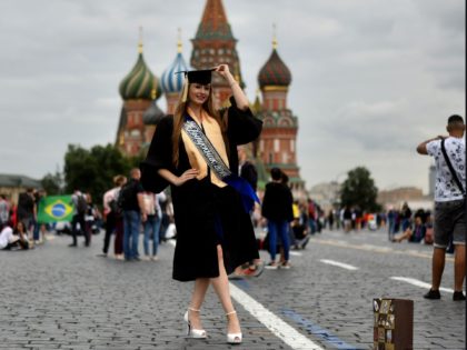 A Russian girl dressed in her graduation gown poses for photographs at Red Square in Moscow on July 10, 2018, on the eve of the Russia 2018 World Cup semi-final football match between between Croatia and England. (Photo by MANAN VATSYAYANA / AFP) (Photo credit should read MANAN VATSYAYANA/AFP via …