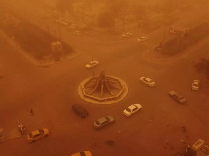 TOPSHOT - An aerial picture shows a view of Iraq's southern city of Nasiriyah during a heavy sandstorm on May 5, 2022. - Iraq is yet again covered in a thick sheet of orange as it suffers the latest in a series of dust storms that have become increasingly common. …