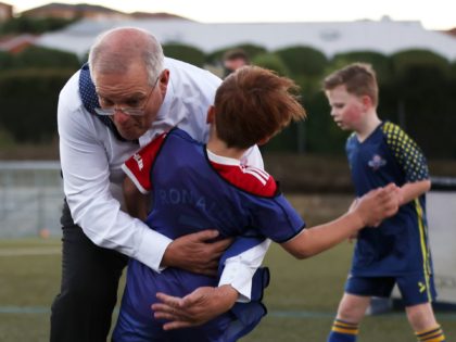 DEVONPORT, AUSTRALIA - MAY 18: Prime Minister Scott Morrison accidentally knocks over a child during a visit to the Devonport Strikers Soccer Club, which is in the electorate of Braddon, on May 18, 2022 in Devonport, Australia. The Australian federal election will be held on Saturday 21 May. (Photo by …