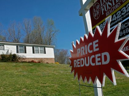 CHESAPEAKE BEACH, MD - APRIL 03: A sign reading "Price Reduced" hangs below a for sale sign in front of a house April 3, 2007 in Chesapeake Beach, Maryland. Although the U.S. stock market rose sharply today, due in part to the announcement better pending sales of previously owned homes …