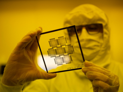 An employee works in the chip manufacturing process at a clean room of the Barcelona Insti
