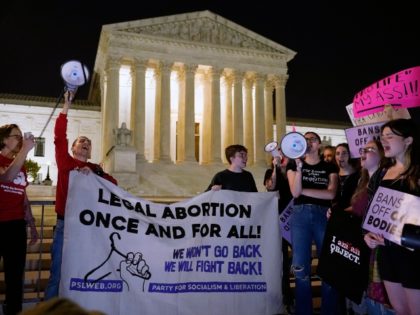 A crowd of people gather outside the Supreme Court, early Tuesday, May 3, 2022 in Washington. A draft opinion circulated among Supreme Court justices suggests that earlier this year a majority of them had thrown support behind overturning the 1973 case Roe v. Wade that legalized abortion nationwide, according to …