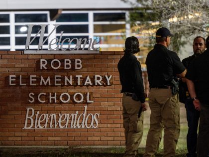 UVALDE, TEXAS - MAY 24: Law enforcement officers speak together outside of Robb Elementary School following the mass shooting at Robb Elementary School on May 24, 2022 in Uvalde, Texas. According to reports, 19 students and 2 adults were killed, with the gunman fatally shot by law enforcement. (Photo by …