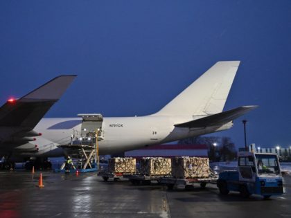Employees unload a plane carrying US military aid at Kyiv's Boryspil airport on February 5, 2022 as US soldiers also arrived in Poland today as part of NATO moves to send in extra troops over fears that Russia could invade Ukraine. - Western capitals have accused Russia of amassing some …
