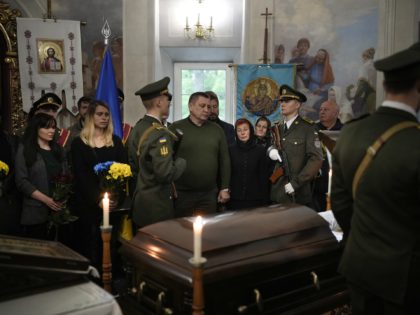 KYIV, UKRAINE - MAY 18: The mother of fallen Ukrainian soldier Denys Antipov mourns at his funeral on May 18, 2022 in Kyiv, Ukraine. Denys Antipov was a soldier and popular economics lecturer at the Kyiv School of Economics he also taught Korean before joining the military to fight for …