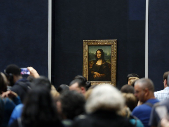 In this Oct.23, 2019 file photo, tourists wait to see Leonardo da Vinci's painting Mona Li