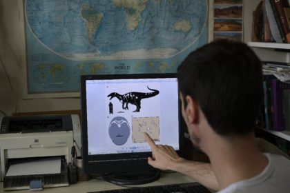 Argentine paleontologist Mauro Aranciaga with a graphic illustration of Maip macrothorax t