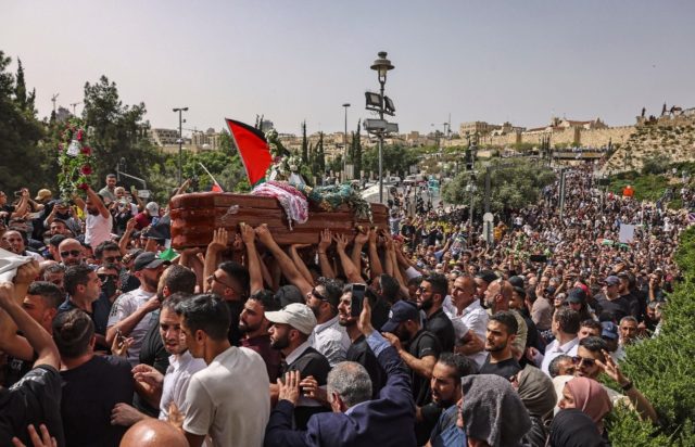 Palestinian mourners carry the casket of slain Al Jazeera journalist Shireen Abu Akleh at