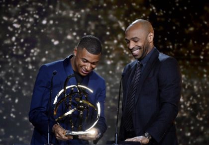 Kylian Mbappe receives his award from former France great Thierry Henry
