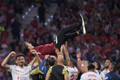Sevilla's players toss their coach Julen Lopetegui into the air after sealing qualification for the Champions League on Sunday.