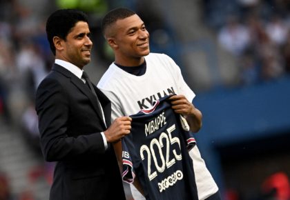 Kylian Mbappe poses with PSG president Nasser Al-Khelaifi after announcing he is staying at the club until 2025