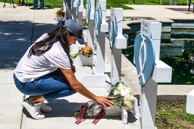 Meghan Markle, the Duchess of Sussex, places flowers at a makeshift memorial outside Uvalde County Courthouse after the mass shooting at an elementary school