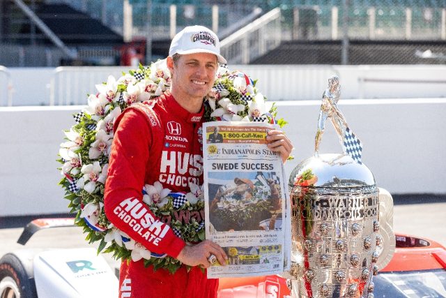 Sweden's Marcus Ericsson poses with his Indianapolis 500 trophy and a newspaper account of
