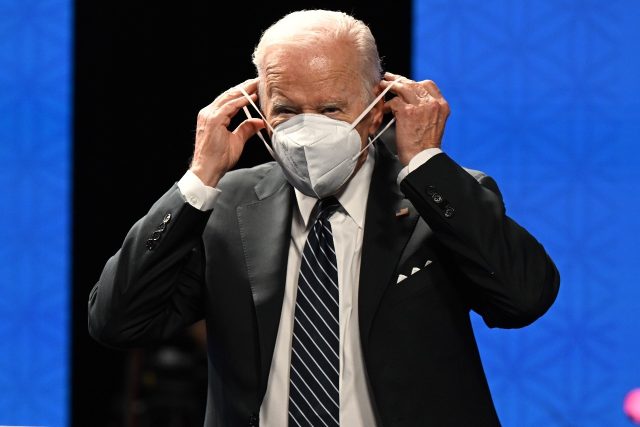 US President Joe Biden adjusts his mask as he launches an Asia-wide trade framework in Tok