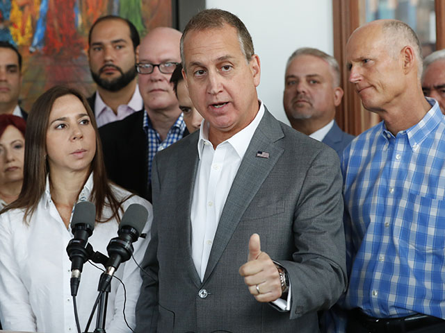 Representative Mario Diaz-Balart, center, R-Fla., speaks to members of the media after he, Sen. Marco Rubio, R-Fla., and Sen. Rick Scott, right, R-Fla., met with Venezuelan, Colombian and Cuban community leaders in support of freedom and democracy in Venezuela, Friday, May 3, 2019, in Doral, Fla. (AP Photo/Wilfredo Lee)