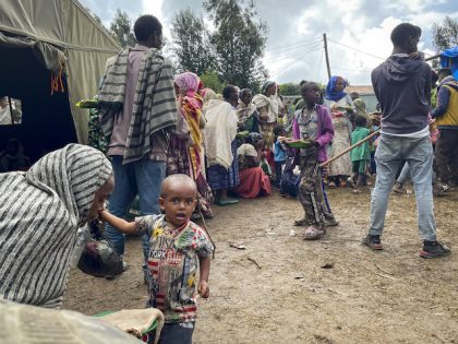 Displaced Amharas from different villages now controlled by Tigrayan forces in the North Gondar zone, queue to receive food at a kindergarten school housing the internally-displaced, in Debark, in the Amhara region of northern Ethiopia Wednesday, Aug. 25, 2021. As they bring war to other parts of Ethiopia such as …