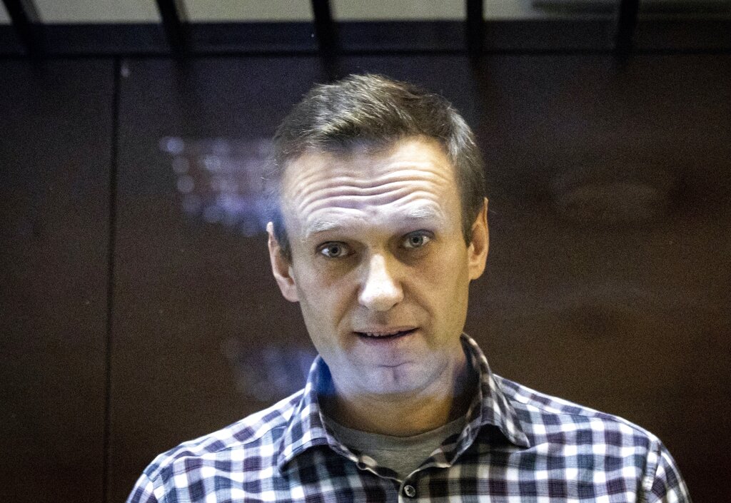 FILE - Russian opposition leader Alexei Navalny looks at photographers standing in the Babuskinsky District Court in Moscow, Russia, Saturday, Feb. 20, 2021.  A documentary film, "Navalny," about one of Vladimir Putin's fiercest and most vocal political foes, premieres on CNN and CNN+ on Sunday. (AP Photo/Alexander Zemlianichenko, File)