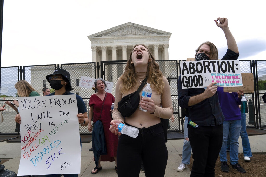 An abortion rights activist demonstrates outside the United States Supreme Court on Thursday, May 5, 2022 in Washington.  A draft opinion suggests the U.S. Supreme Court may be on the verge of overturning the landmark 1973 Roe v. Wade case that legalized abortion nationwide, according to a Politico report released Monday.  Regardless of the outcome, the Politico report represents an extremely rare violation of the court's secret deliberative process, and on a matter of momentous importance.  (AP Photo/Jose Luis Magana)