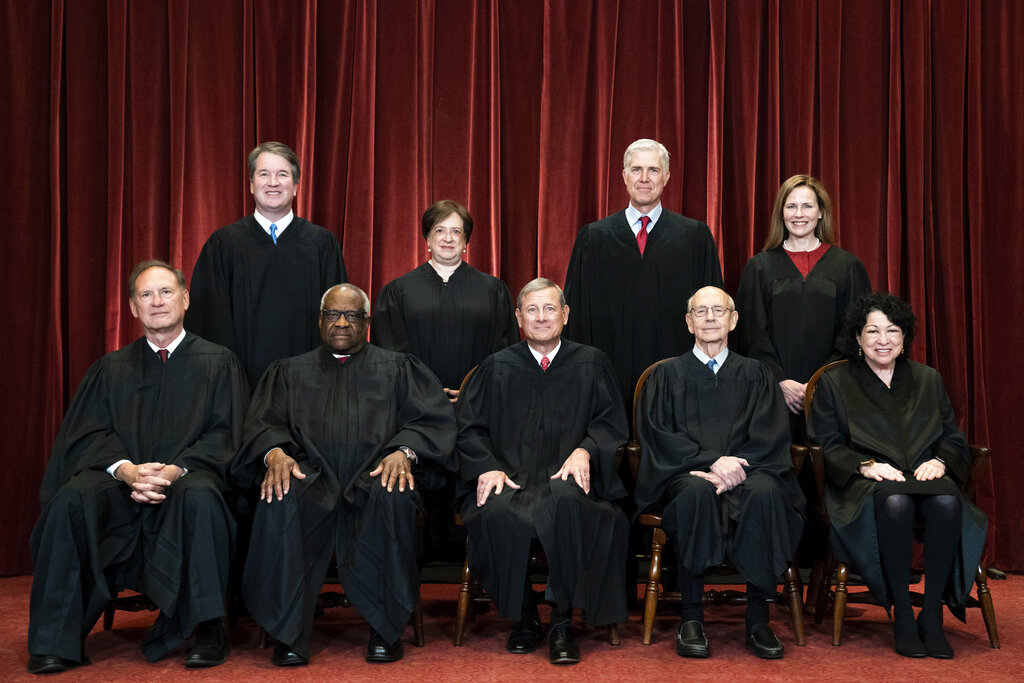 FILE - Members of the Supreme Court pose for a group photo at the Supreme Court in Washington, April 23, 2021. Seated from left are Associate Justice Samuel Alito, Associate Justice Clarence Thomas, Chief Justice John Roberts, Associate Justice Stephen Breyer and Associate Justice Sonia Sotomayor, Standing from left are Associate Justice Brett Kavanaugh, Associate Justice Elena Kagan, Associate Justice Neil Gorsuch and Associate Justice Amy Coney Barrett. In one form or another, every Supreme Court nominee is asked during Senate hearings about his or her views of the landmark abortion rights ruling that has stood for a half century. Now, a draft opinion obtained by Politico suggests that a majority of the court is prepared to strike down the Roe v. Wade decision from 1973, leaving it to the states to determine a woman’s ability to get an abortion. (Erin Schaff/The New York Times via AP, Pool, File)