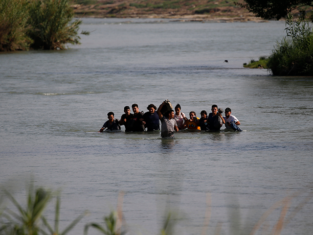 Migrants, mostly from Nicaragua, cross the Rio Grande river into the U.S., at Eagle Pass,