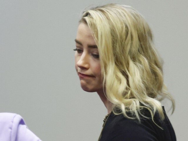 Actor Amber Heard reacts with her lawyer Elaine Bredehoft after the verdict was read at th