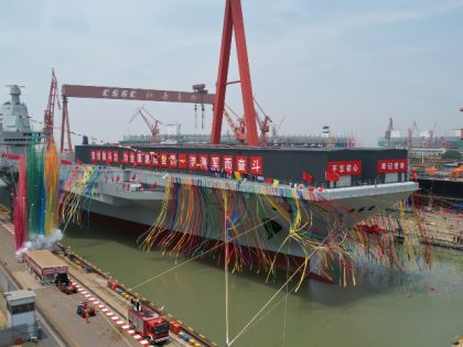 In this photo released by Xinhua News Agency, coloured smoke mark the launch ceremony for China's third aircraft carrier christened Fujian at a dry dock in Shanghai on Friday, June 17, 2022. China on Friday launched its third aircraft carrier, the first such ship to be both designed and built …