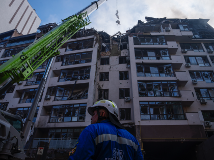 Firefighters work at the scene at a residential building following explosions, in Kyiv, Ukraine, Sunday, June 26, 2022. Several explosions rocked the west of the Ukrainian capital in the early hours of Sunday morning, with at least two residential buildings struck, according to Kyiv mayor Vitali Klitschko. (AP Photo/Nariman El-Mofty)