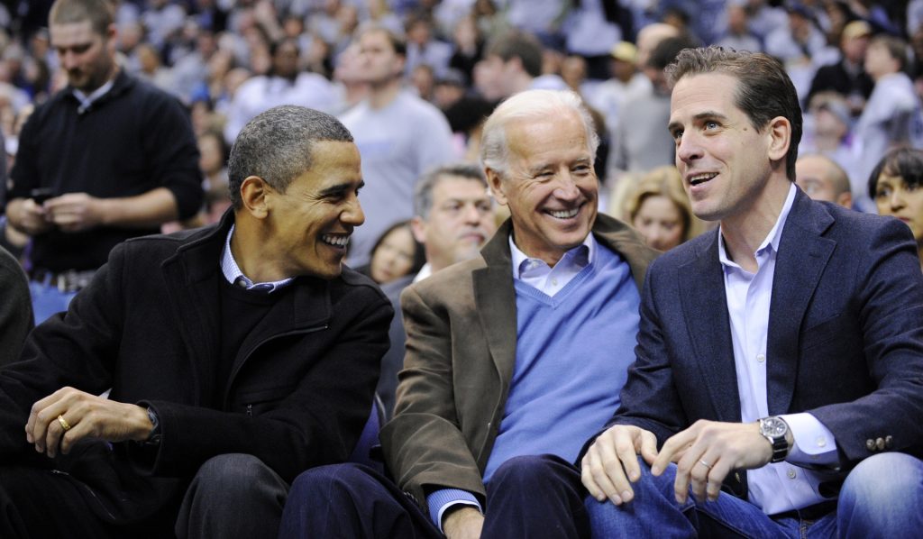 This Jan. 30, 2010 file photo shows Hunter Biden, right, son of Vice President Joe Biden, center, talking with President Barack Obama, and the vice president Joe Biden during a college basketball game in Washington. Biden's youngest son Hunter is joining the Navy. The Navy says the attorney and former Washington lobbyist was selected to be commissioned into the Navy Reserve as a public affairs officer. Because he is 42, he needed a special waiver to be accepted, but that is not uncommon. He is one of seven candidates recommended for a direct commission for public affairs. (AP Photo/Nick Wass, File)