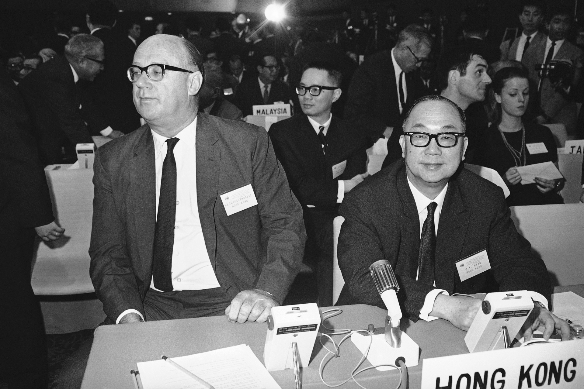 Hong Kong representatives John James Cowperthwaite, left, and C. Y. Kwan are at a meeting of the United Nations Economic Commission for Asia and the Far East in a Tokyo Hotel on April 3, 1967. (AP Photo)