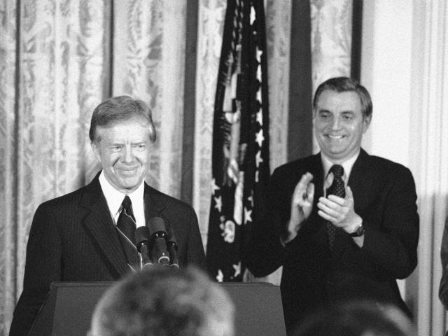 Vice-President Walter Mondale applauds as President Jimmy Carter finishes his announcement that he will seek re-election, in the East Room of the White House in Washington on Dec. 4, 1979. (AP Photo)
