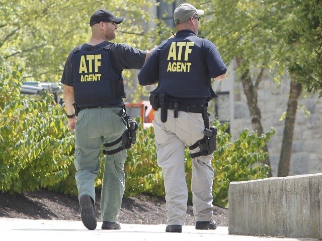 ATF officers patrol around Dietrick Hall after a lockdown of the campus was lifted at the school in Blacksburg, Va., Thursday, Aug. 4, 2011. (Steve Helber/AP)