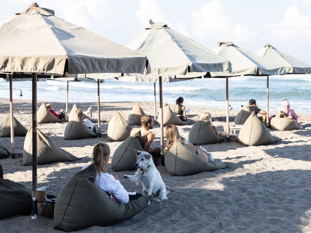 Foreign tourists at a beach side cafe in Canggu, Bali, Indonesia, on Friday, May 6, 2022. With the broader reopening, fully vaccinated visitors from overseas to Bali no longer need to quarantine. Photographer: Putu Sayoga/Bloomberg via Getty Images