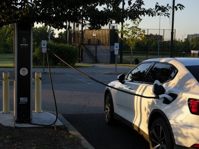 LEONIA, NEW JERSEY - JUNE 17: The sun set behind EV charging stations on June 17, 2022 in