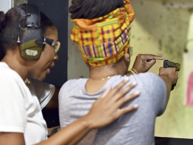 In this May 27, 2017, photo, Marchelle Tigner, a firearms instructor, teaches a student how to shoot a gun during a class in Lawrenceville, Georgia. Tigner's goal is to train 1 million women how to shoot a gun in her lifetime. She is among the nation's black women gun owners …
