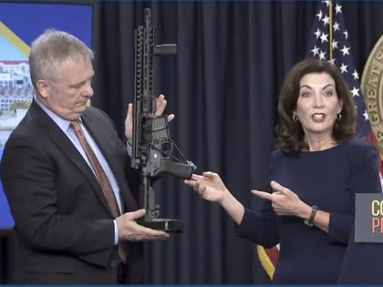 In this image taken from video, Kevin Bruen, Superintendent of the New York State Police, holds a firearm as New York Gov. Kathy Hochul speaks during a news conference, Wednesday, May 18, 2022, in New York. New York would require state police to seek court orders to keep guns away …