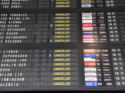 A flight information board shows cancelled flights due to a strike of security guards on J