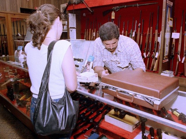 A customer is shown at the Tamiami Gun Shop in Miami, Florida, on October 1, 1987. Under a new Florida law that goes into effect today, Floridians who have obtained the new state concealed gun permit will be allowed to carry sidearms openly or concealed. (Kathy Willens/AP)