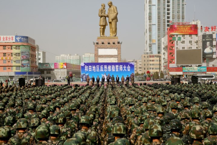 This file photo taken on February 27, 2017 shows Chinese military police attending an anti-terrorist oath-taking rally in Hotan, also known as Hetian, in northwest China's Xinjiang Uyghur Autonomous Region. On state television, the “vocational education center” in China's far west looked like a modern school where happy students studied Mandarin, brushed up their job skills, and pursued hobbies such as sports and folk dance. But earlier this year, one of the local government departments in charge of such facilities in Xinjiang's Hotan prefecture made several purchases that had little to do with education: 2,768 police batons, 550 electric cattle prods, 1,367 pairs of handcuffs, and 2,792 cans of pepper spray. 